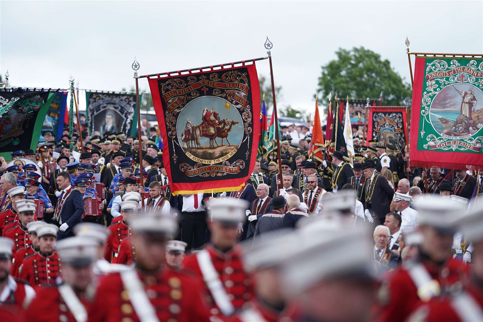 Band members and members of the Royal Black Preceptory parade through Scarva, Co Down (Niall Carson/PA)