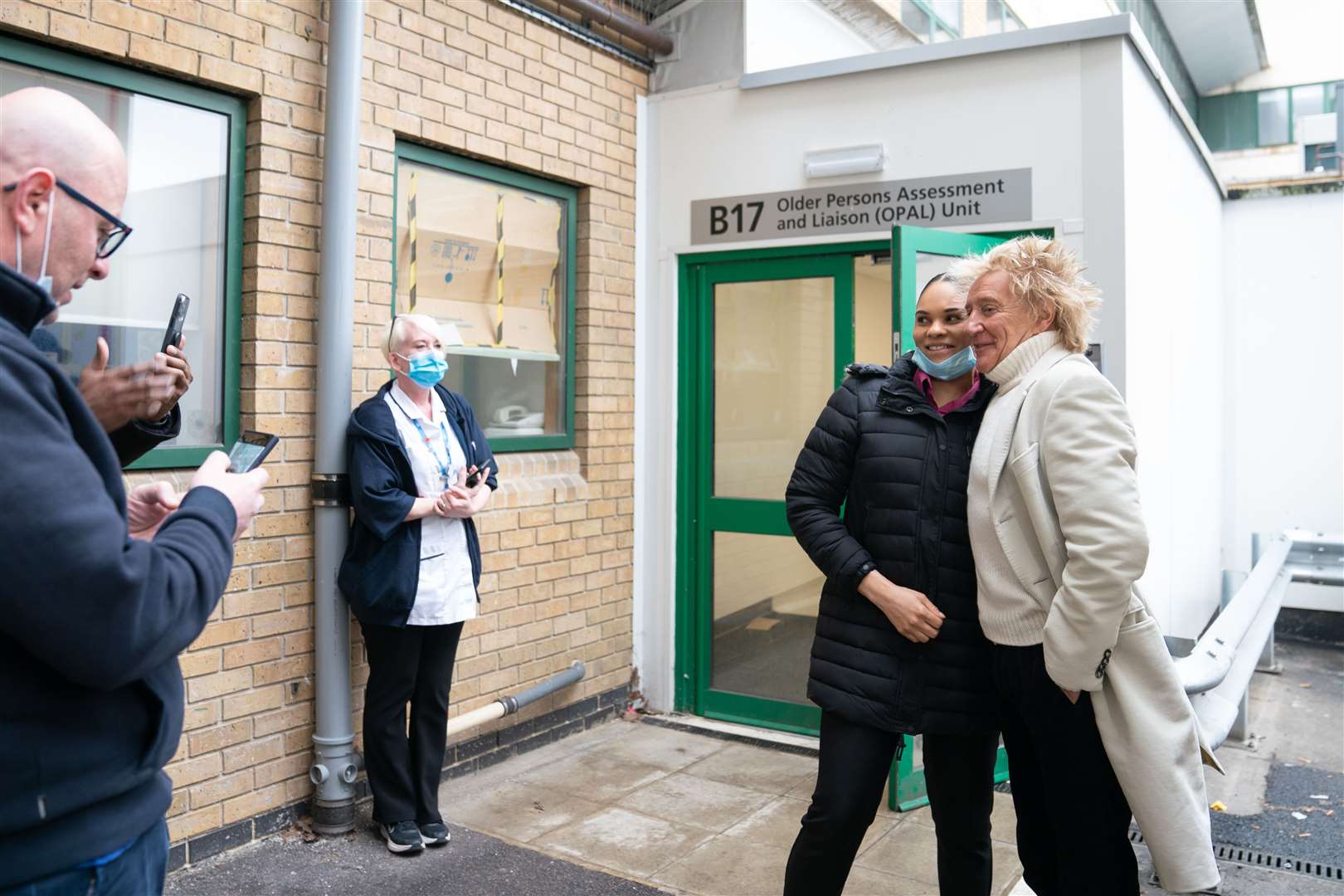Sir Rod Stewart poses for photos with members of staff at the Princess Alexandra Hospital in Harlow (Joe Giddens/PA)