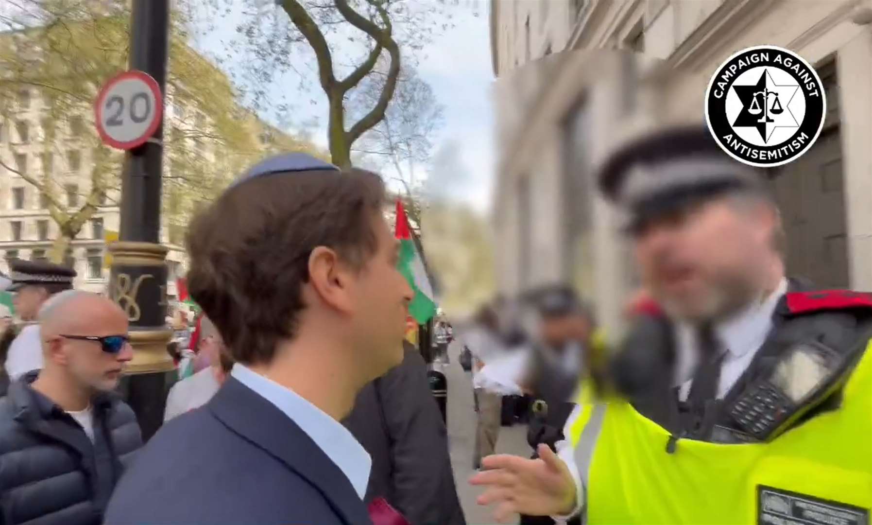 Gideon Falter speaking to a Metropolitan Police officer (Campaign Against Antisemitism/PA)