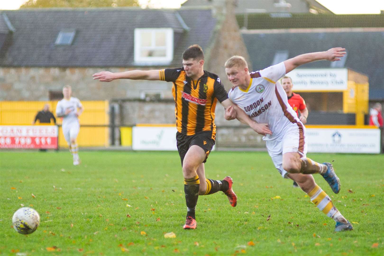 Huntly's Glenn Murison (left) and Forres' Lee Fraser tussle to win the ball. Picture: Daniel Forsyth..
