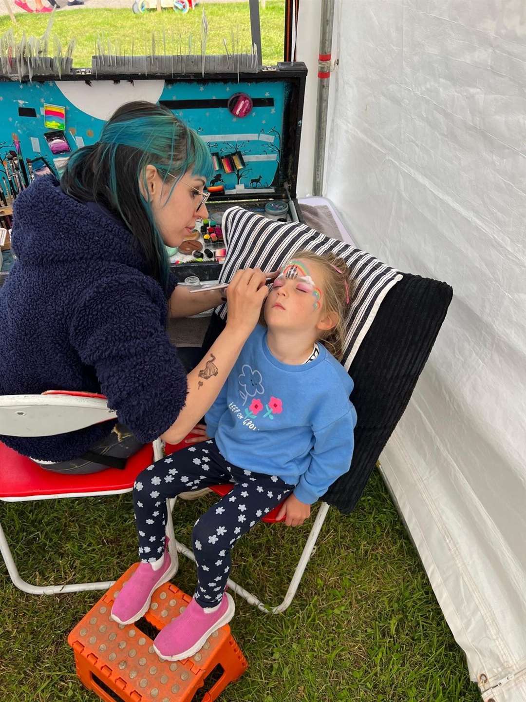 Eve McGinley (3) from Glasgow having her face painted in the children's corner.