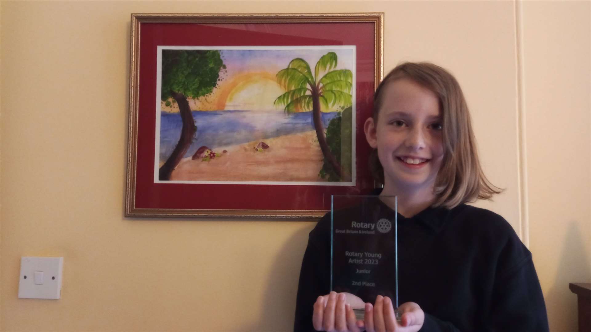 Alice with her award-winning landscape painting.
