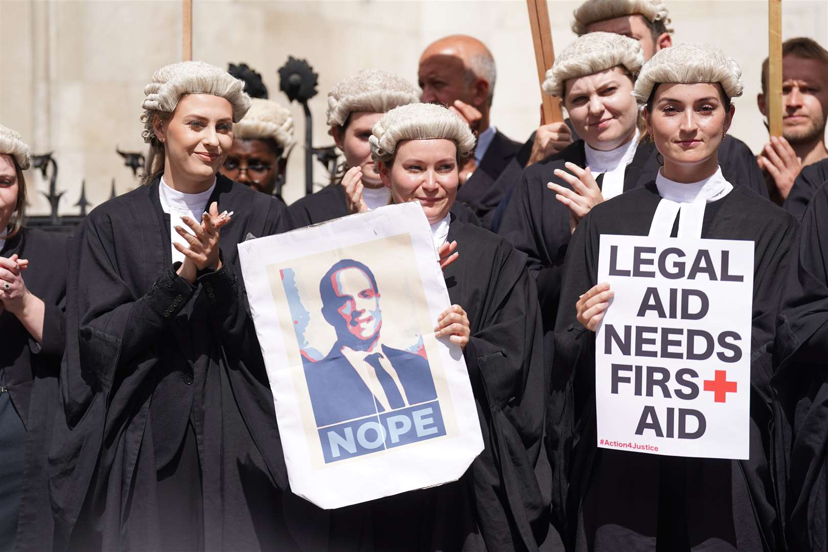 Criminal defence barristers gather outside the Royal Courts of Justice during an earlier strike (PA)
