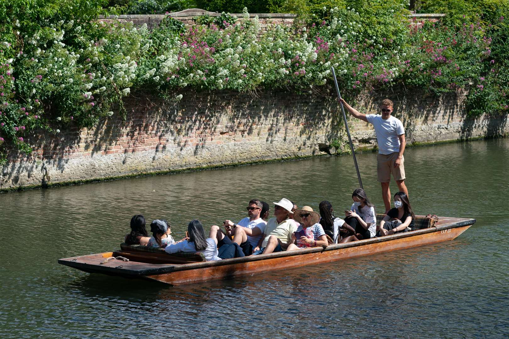 People enjoy the hot weather as they punt along the River Cam in Cambridge (Joe Giddens/PA)