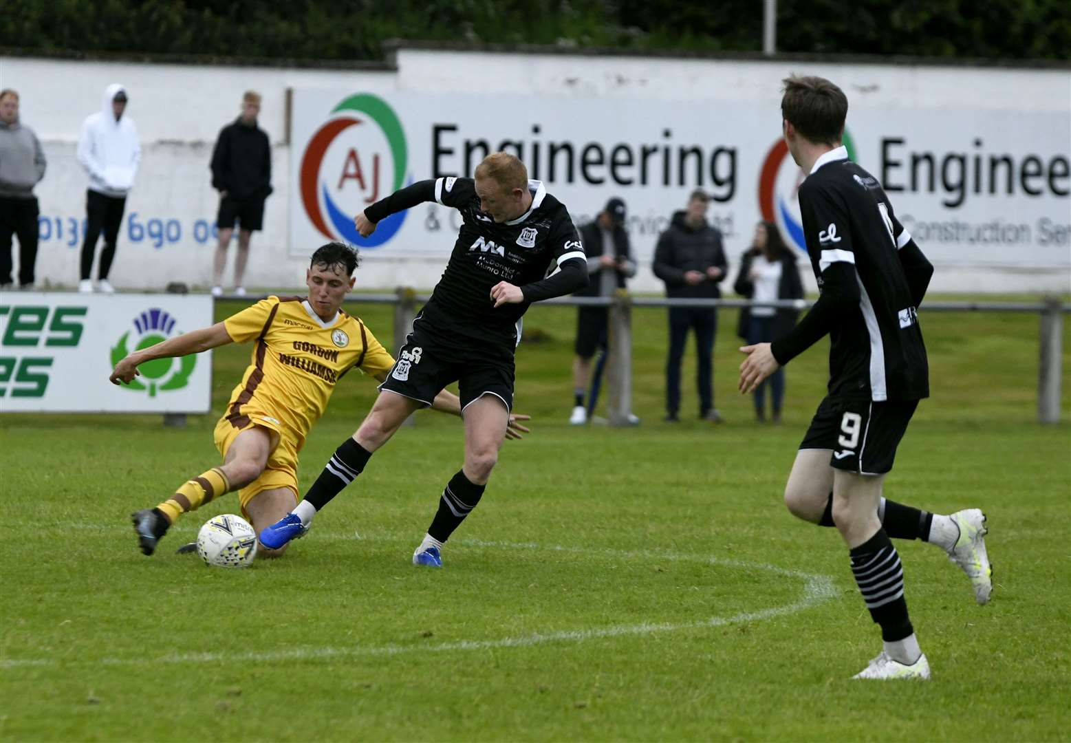 Forres Mechanics' Callum Johnston and Elgin City's Russell Dingwall fighting to get the ball...Fraser Twins Testimonial Match..Picture: Beth Taylor.
