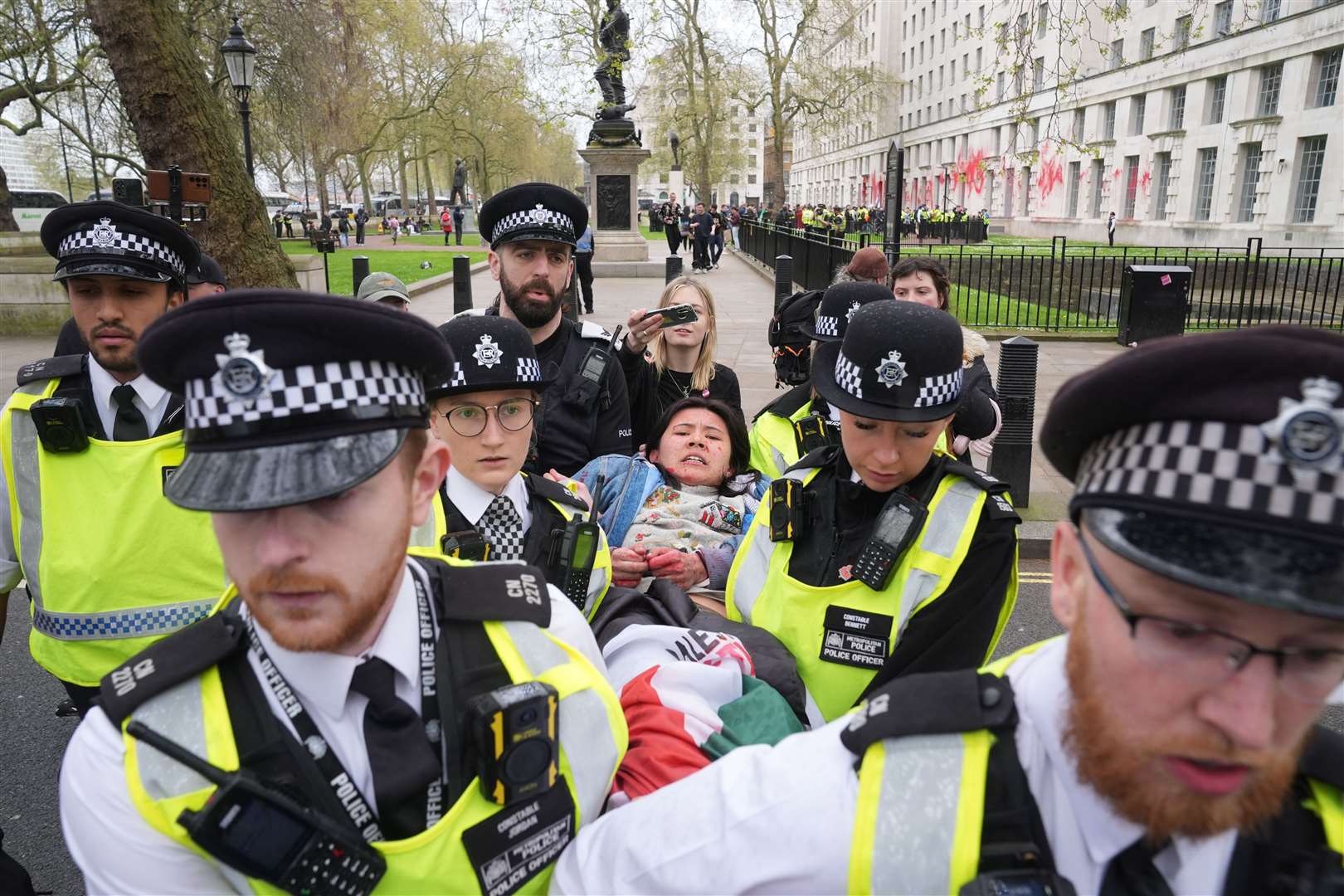 An alleged protester is carried off by police (Lucy North/PA)