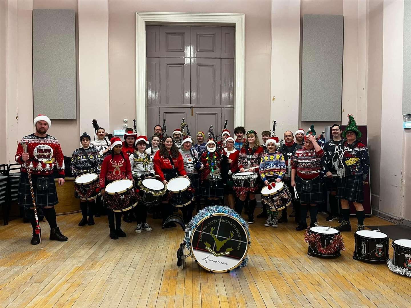 Forres and District Pipe Band members looking festive at Forres Town Hall before Christmas.