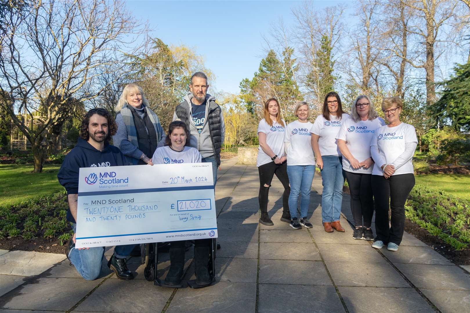 Handing over the cheque for £21,000, from left, Jonathan Mitchell (Fundraising Leader & Events Manager MND Scotland), Lydia Lintott (mum), Lucy Smith, Robert Lintott (dad), Samatha McKay, Mary Smith, Michelle Anderson, Tracy Stevenson and Kay Jackson.Picture: Beth Taylor.