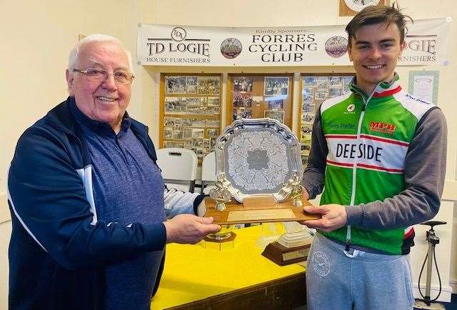 Peter Robertson of Forres CC presenting the Bill and Chrissie Stuart Memorial Trophy to Calum Gibb.