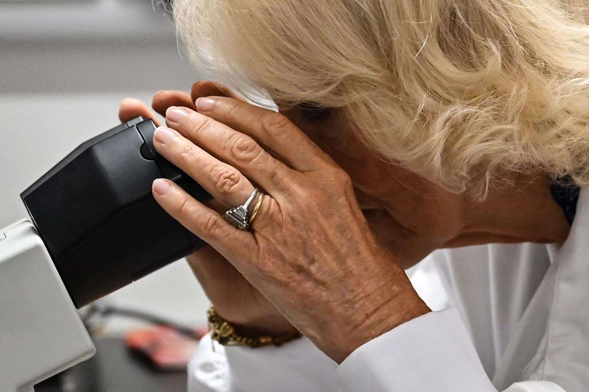 The Queen looked into a microscope during her visit to learn about research work into type 1 diabetes (Justin Tallis/PA)