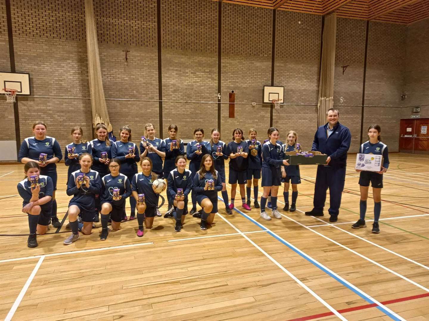 Forres Girls FC under-14s and coach Jamie Alexander at Forres House Community Centre.