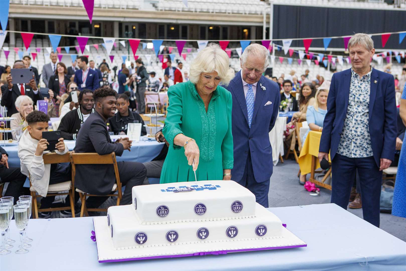 Charles and Camilla cut a cake (Jamie Lorriman/Daily Telegraph/PA)
