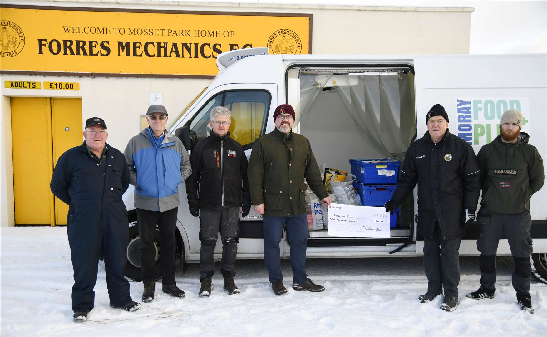 Club officials helping to load up the Moray Food Plus van with essentials. Picture: Beth Taylor