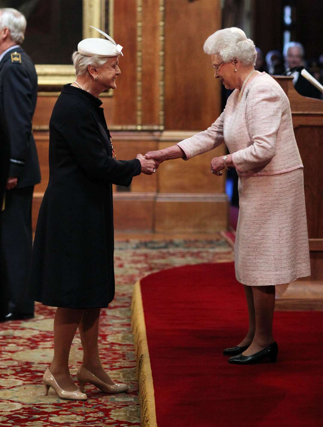 Angela Lansbury receiving her damehood from the Queen in 2014 (Jonathan Brady/PA)