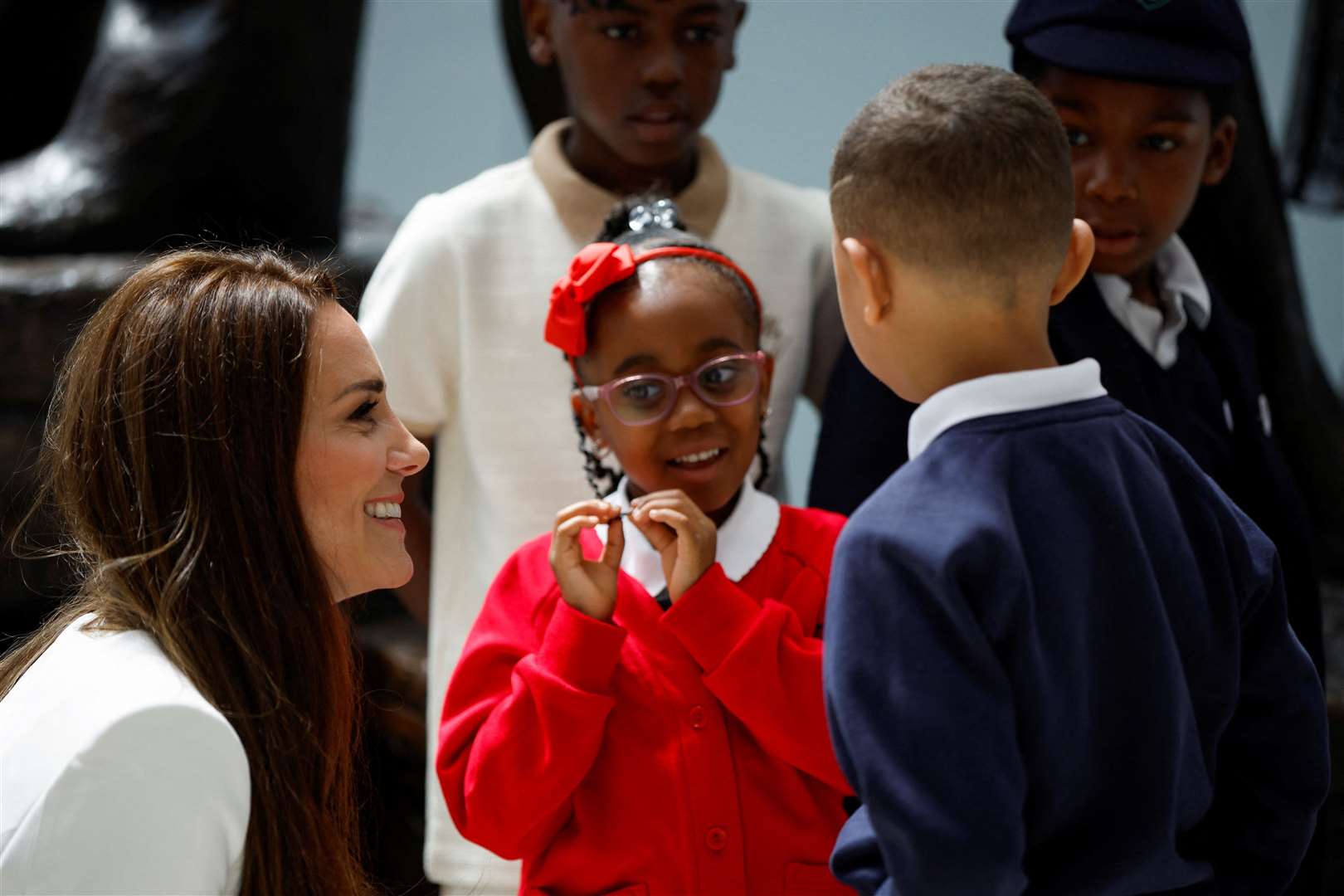 The Duchess of Cambridge speaks with children at the unveiling (John Sibley/PA)