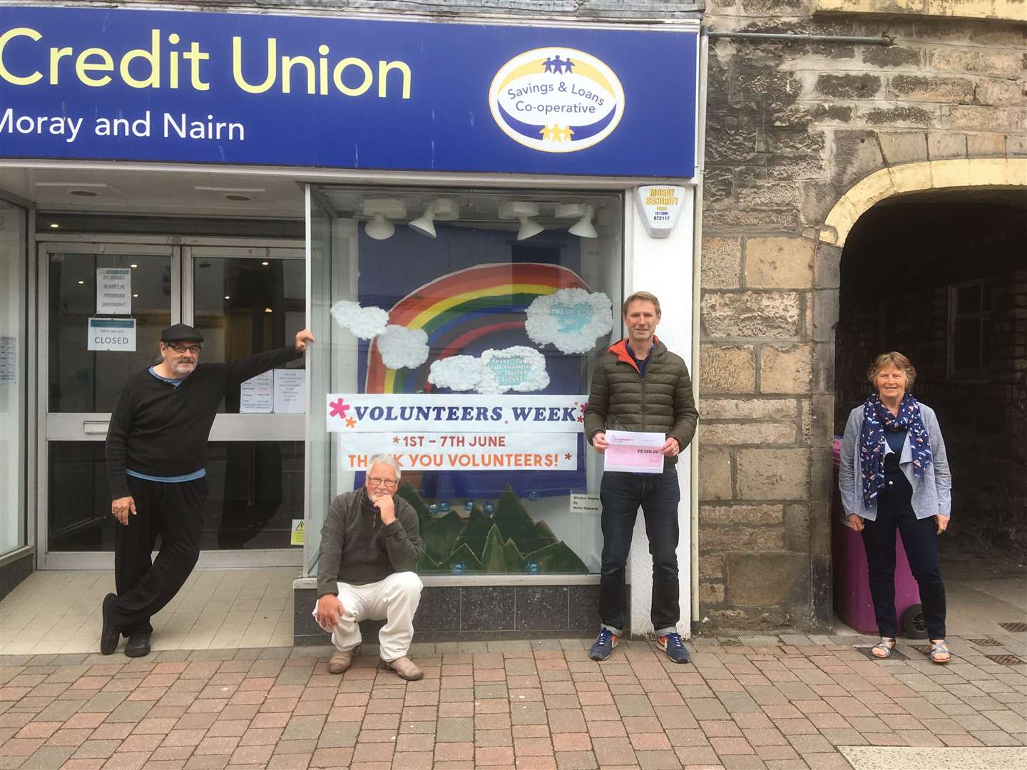 Bob Kenny, Tim Flood, Gareth Edwards and Lorna Creswell with the cheque, outside Forres Area Credit Union during Volunteering Week.
