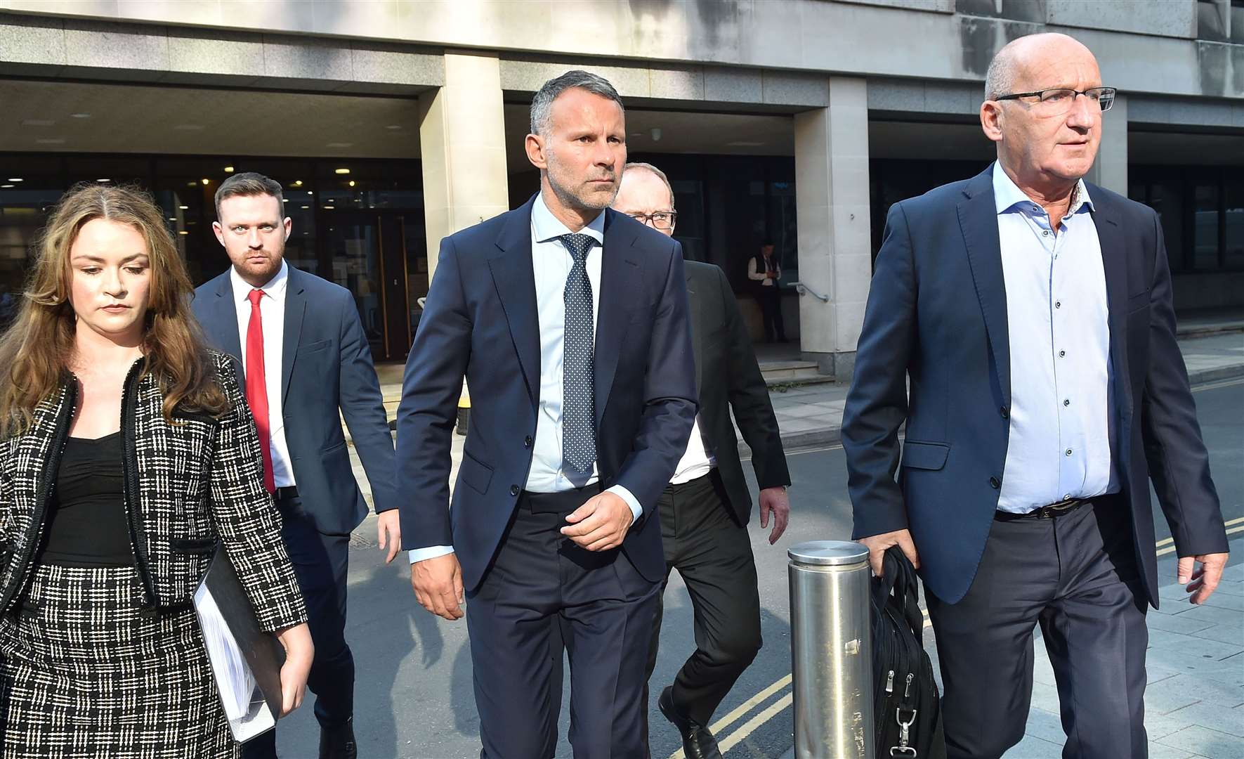 Former Manchester United footballer Ryan Giggs (centre) leaves court (Steven Allen/PA)