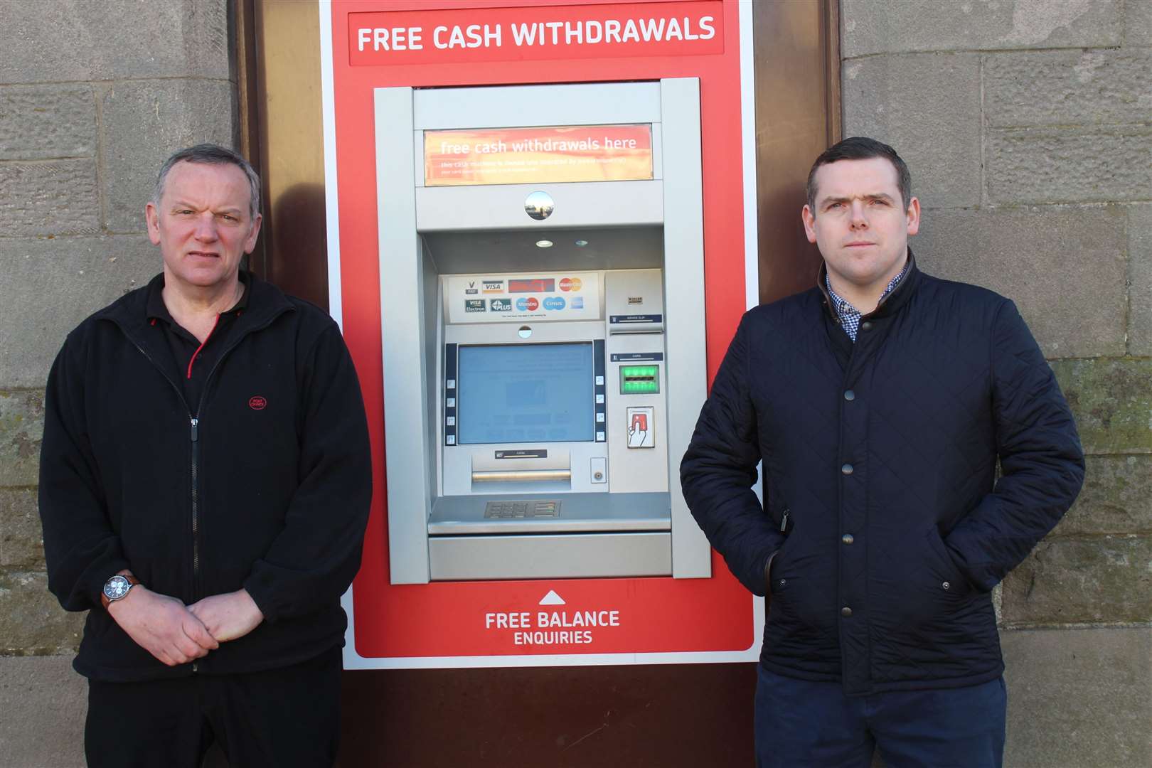 Postmaster Paul McBain (left) with Moray MP Douglas Ross beside the ATM in question.