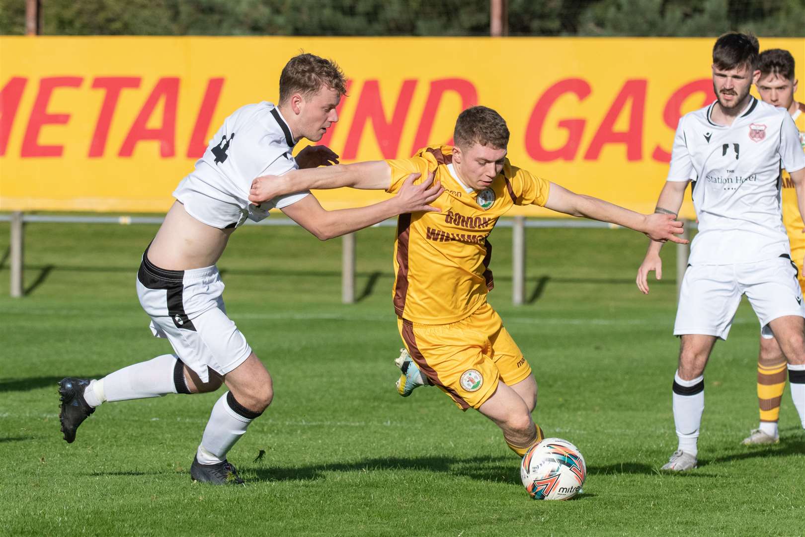 Rothes' Ben Johnstone tries to keep a hold of Forres' Craig Mackenzie. Picture: Daniel Forsyth..