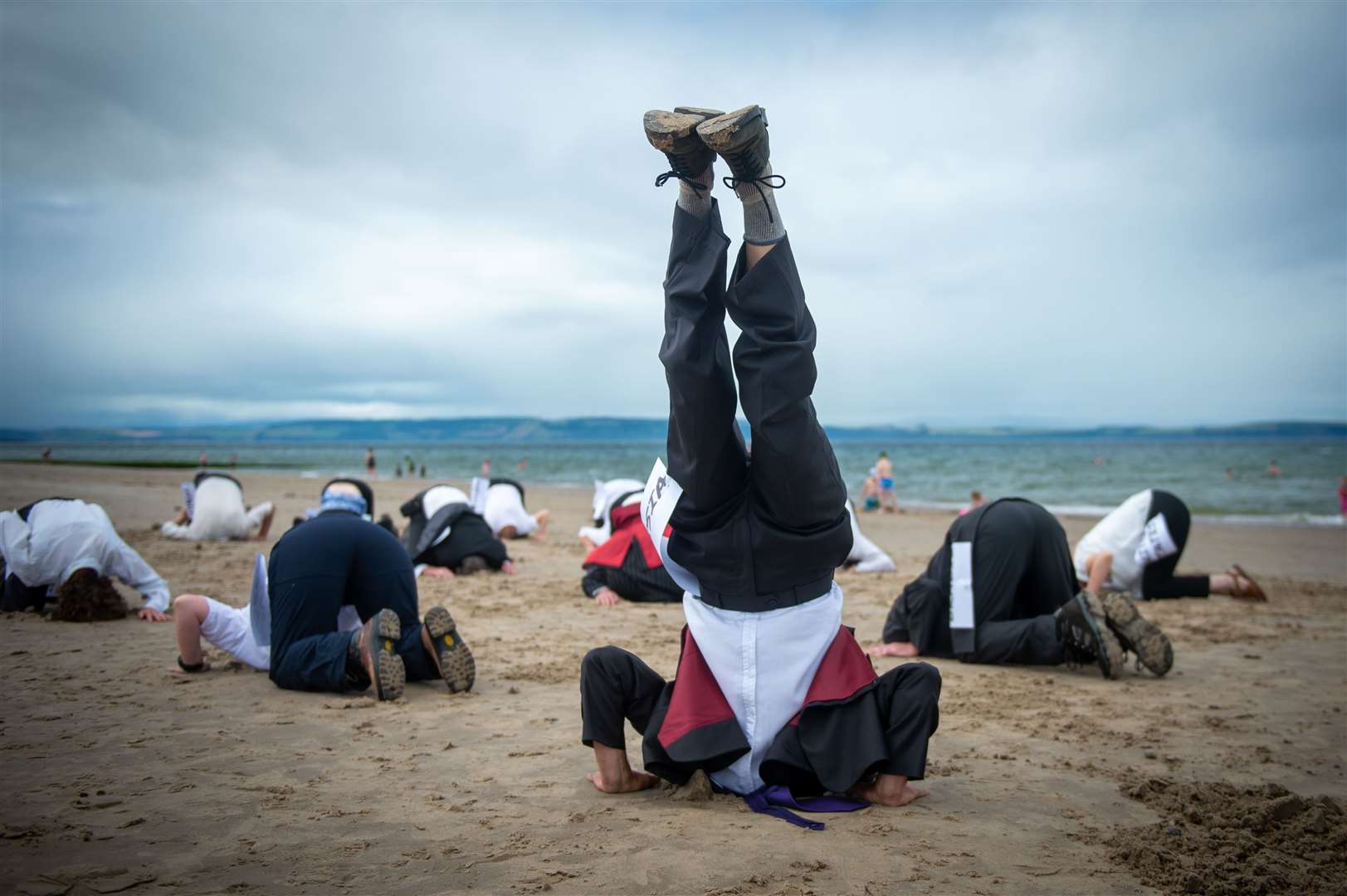 Extinction Rebellion's Head in the Sand action, at Nairn Beach. Picture: Callum Mackay.
