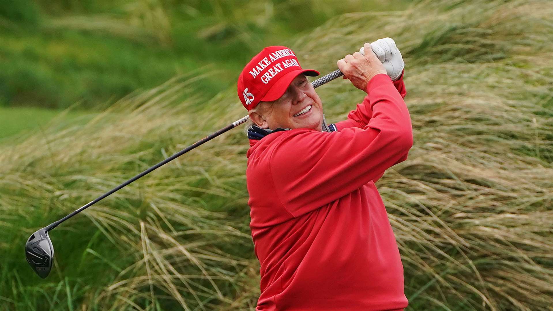Former US president Donald Trump on the 4th tee at Trump International Golf Links & Hotel (Brian Lawless/PA)