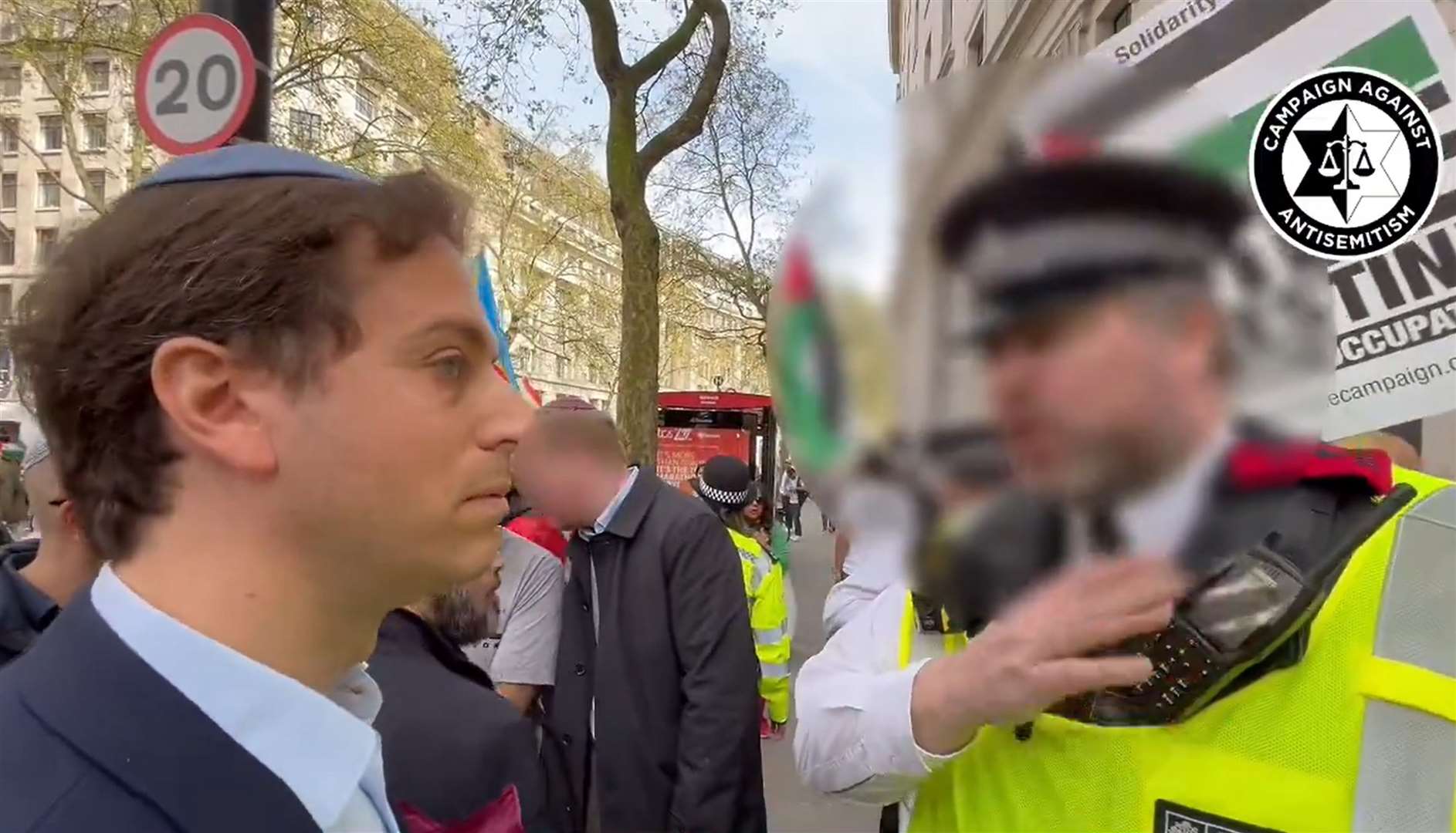 A screengrab of Gideon Falter speaking to an officer during march (Campaign Against Antisemitism/PA)