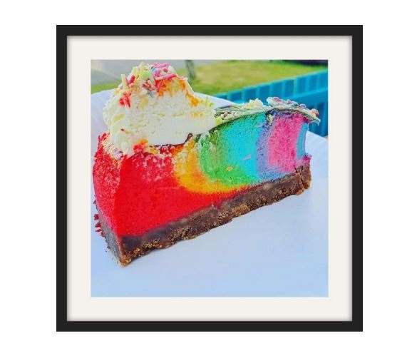 A photograph of a rainbow cake by Kristin Edward.