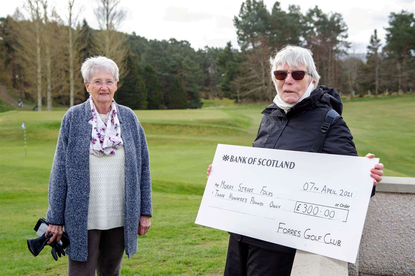 Dorothy Marshall (right) hands a cheque for £300 over to Rosemary Warde, chairwoman of Moray Stroke Folks.