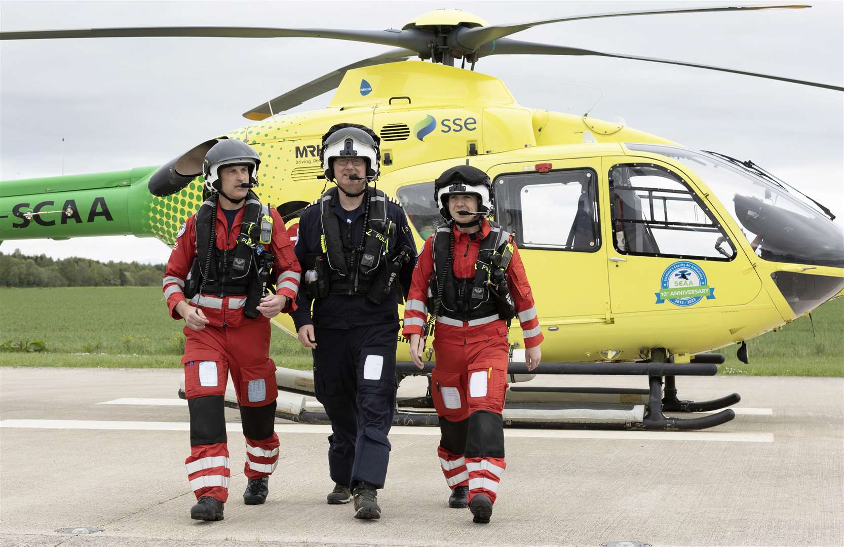 Scotland's Charity Air Ambulance (SCAA) marks its 10th anniversary. Pictured from left to right, the day's duty crew, Lead Paramedic John Pritchard, Pilot Captain Russell Myles and Paramedic Ali Daw. Picture: Graeme Hart