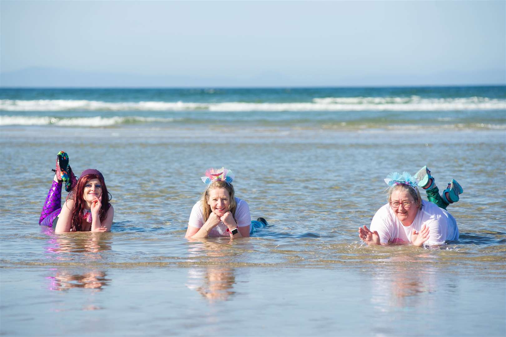 From left: Dee Ryan-Glass, Moira Middleton and Debi Weir as mermaids for their Kiltwalk challenge at Findhorn. Picture: Daniel Forsyth.