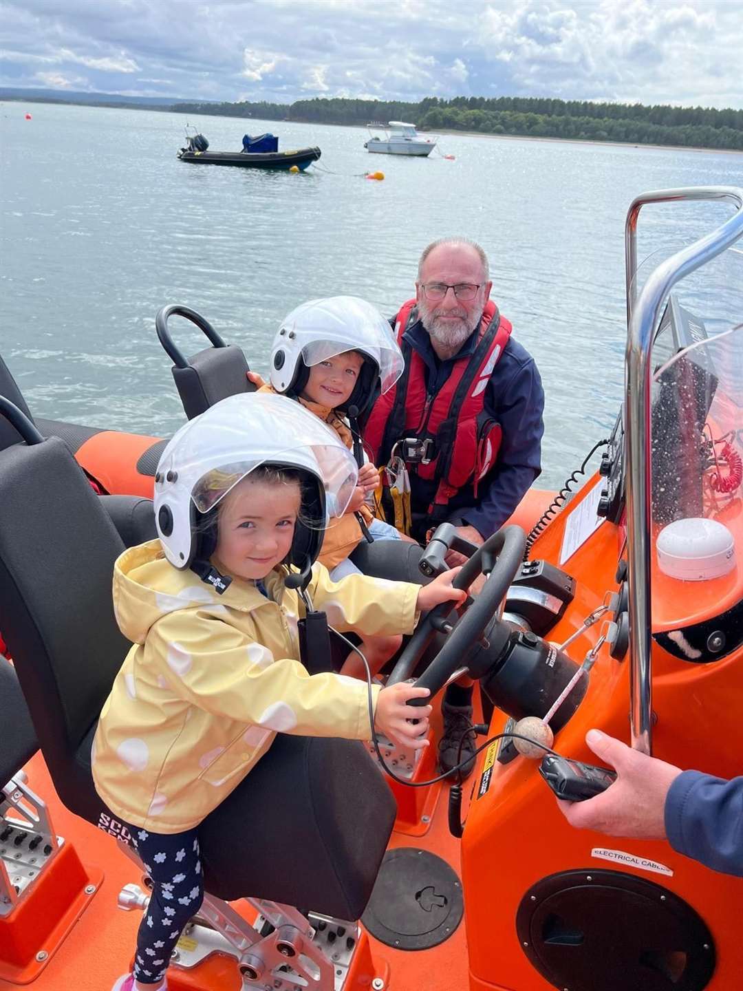 Daniel (6) and Eve (3) McGinley from Glasgow enjoying their visit to MIRO Rescue as helm, Steve Leslie, watches on.