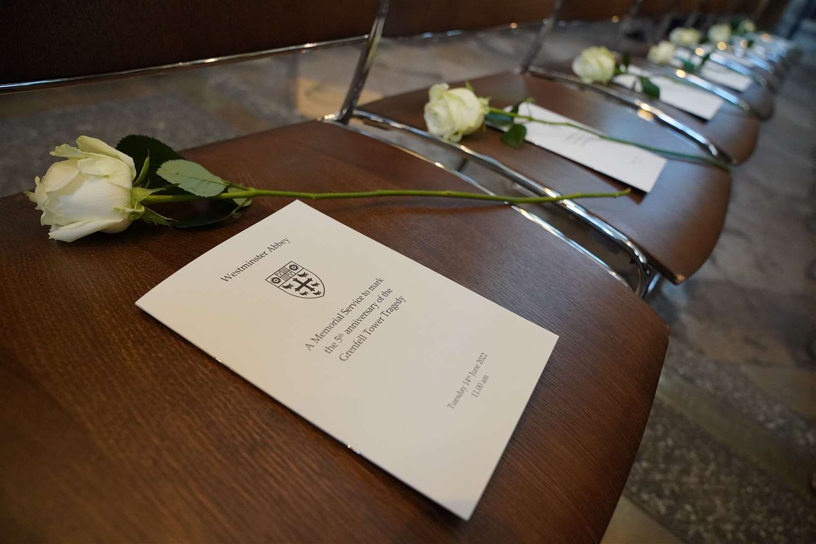 An order of service and white rose were placed on chairs at the memorial service at Westminster Abbey (Jonathan Brady/PA)