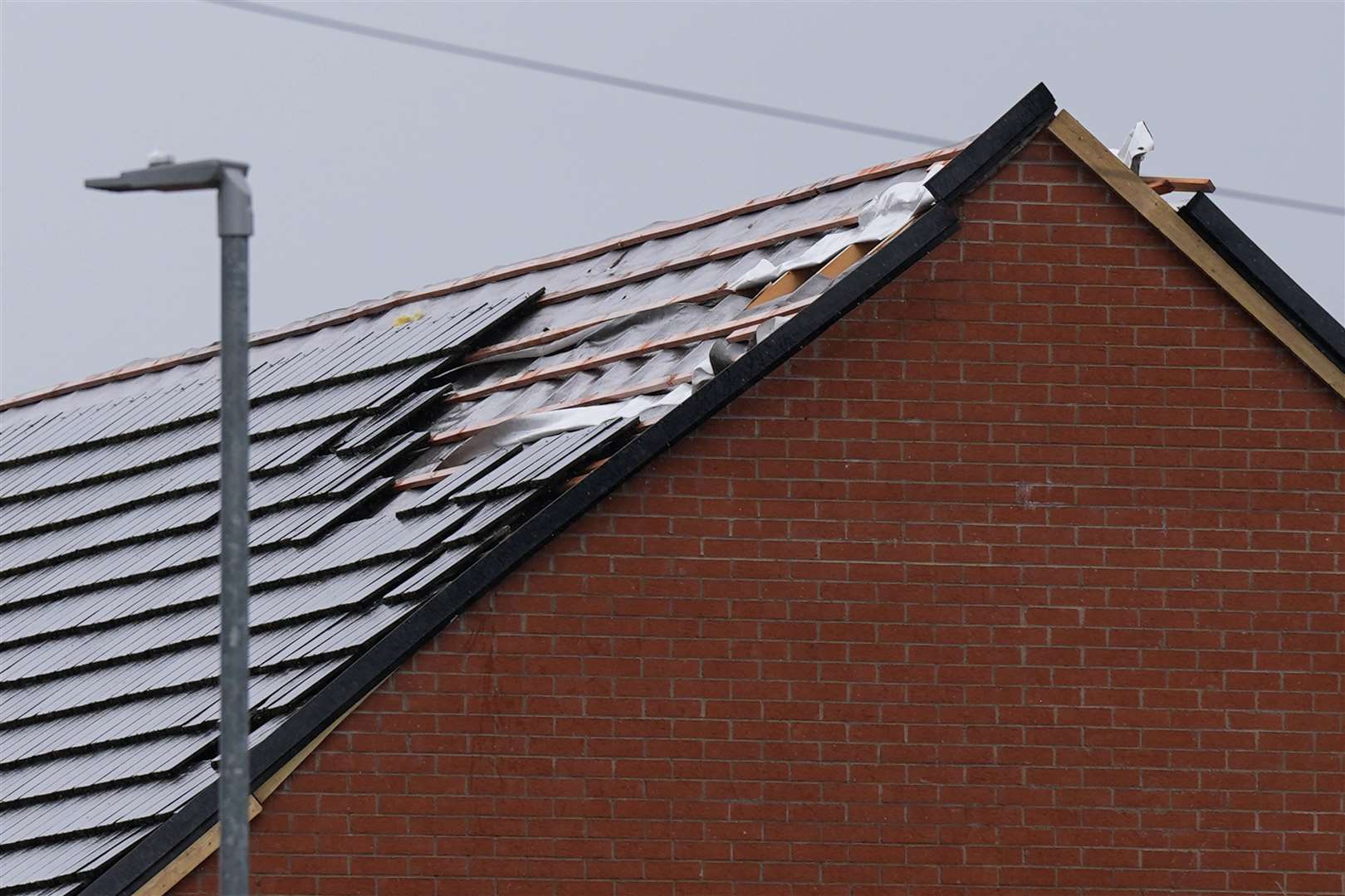 Tiles have been ripped off the roofs of some homes in St Giles Road, Knutton (Jacob King/PA)