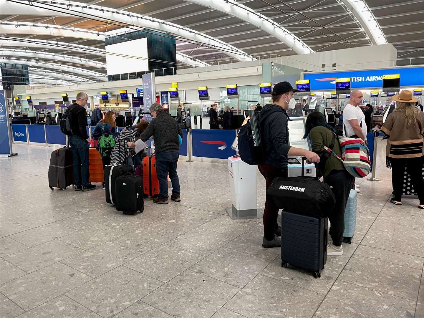 Passengers wait in line to check in at Terminal 5 of Heathrow Airport (Jordan Pettitt/PA)