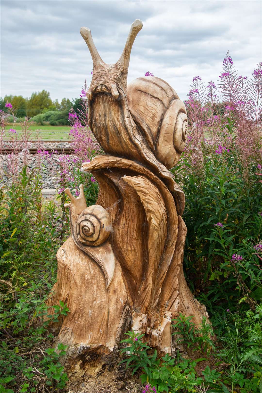 A nearby stump has been carved.