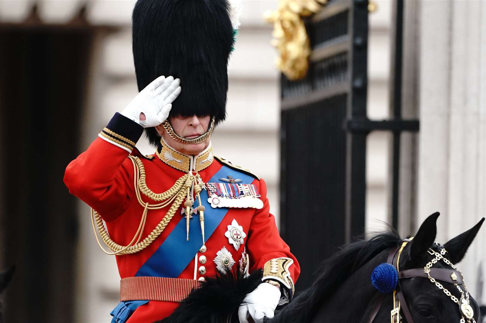 The King salutes as he departs Buckingham Palace for the Trooping the Colour ceremony at Horse Guards Parade (Victoria Jones/PA)