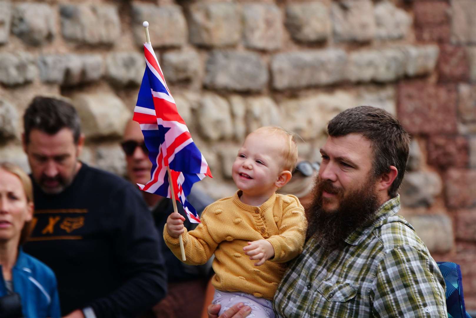 A small child holds a union flag ahead of the proclamation ceremony (Ben Birchall/PA)