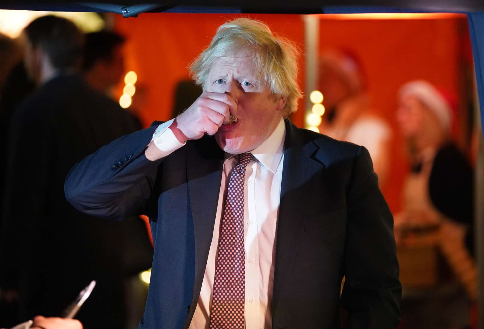 Boris Johnson samples the goods as he visits a UK Food and Drinks market set up in Downing Street on Tuesday (Stefan Rousseau/PA)