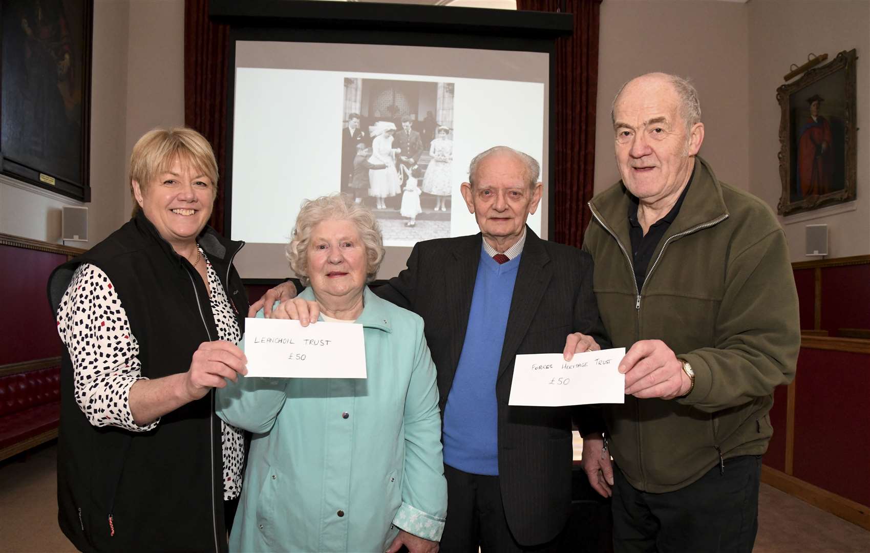 Jo Lenihan of the Leanchoil Trust and George Alexander of Forres Heritage Trust accept donations of £50 each from the Haywoods. Picture: Becky Saunderson