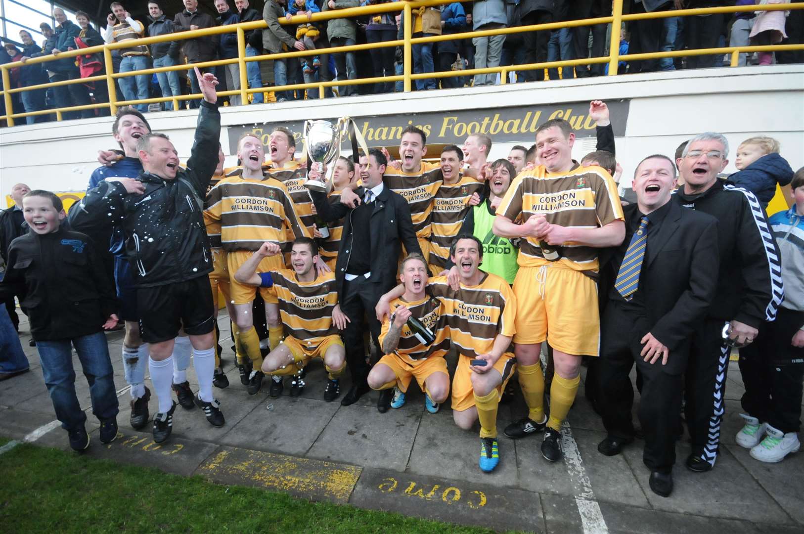 Forres Mechanics players and staff celebrate the title success. Picture: Eric Cormack