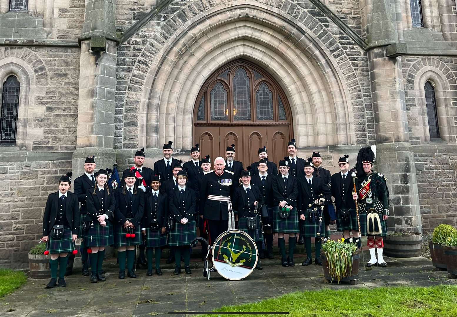 Forres and District Pipe Band with band president Lord Lieutenant Major General Seymour Monro after performing at St Laurence Church service of thanksgiving for King Charles III.