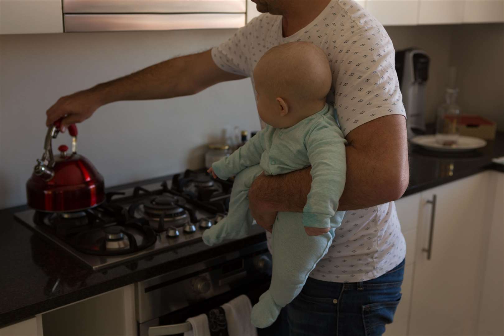 Just over 200,000 fathers took paternity leave in 2021/22, compared to 636,000 mothers (Alamy/PA)