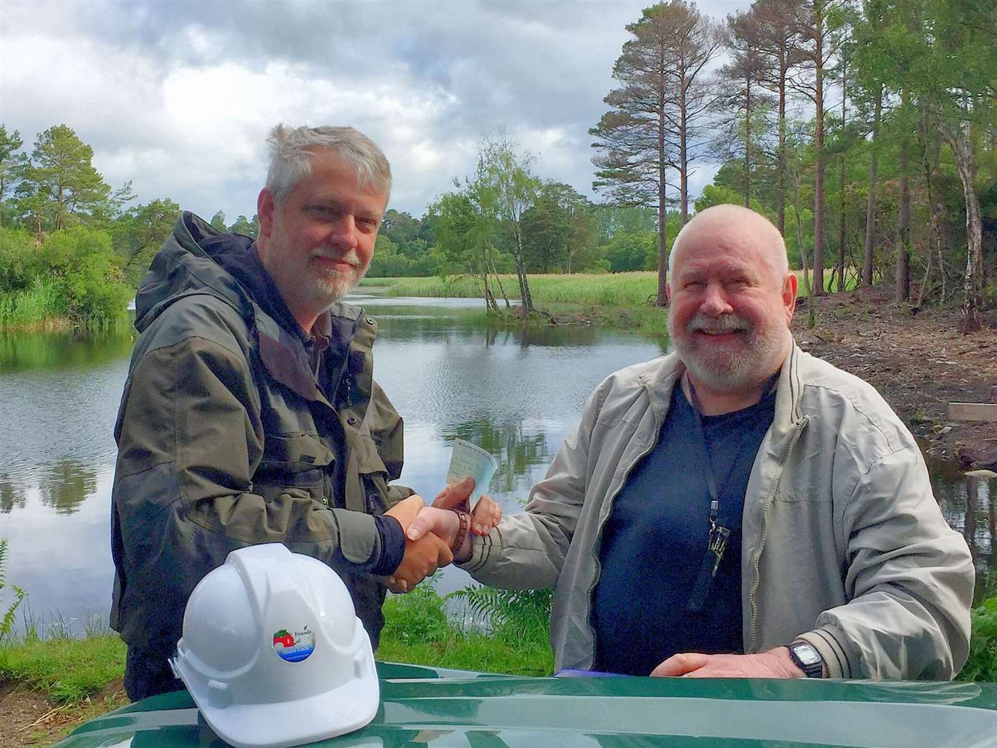 Colin (right) presenting donation to Friends of Blairs Loch Treasurer, Brian Higgs.