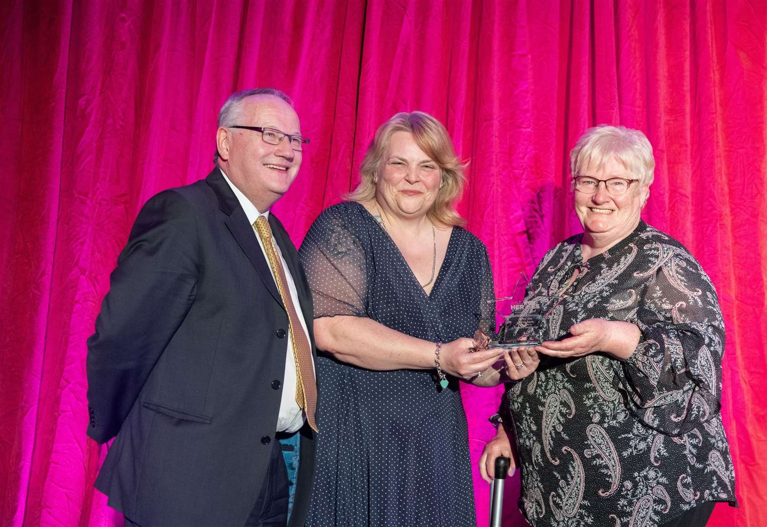 Meg Jamieson (right) and Gifford Leslie accept the Community Champion of the Year award on behalf of Buckie's Roots from Roz Cassidy, the HR Manager of Walker's Shortbread. Picture: Beth Taylor