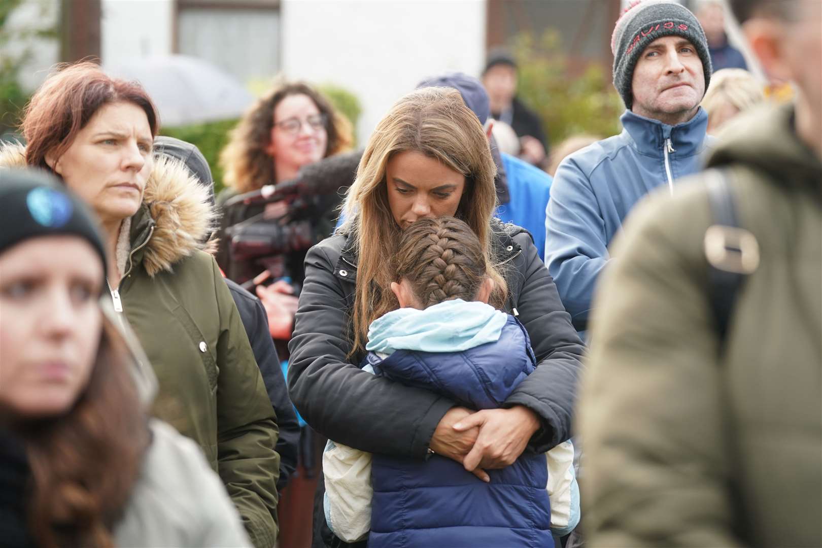 Louise Devine with her daughter Lilly Hegarty, eight, at a vigil in Milford (Brian Lawless/PA)