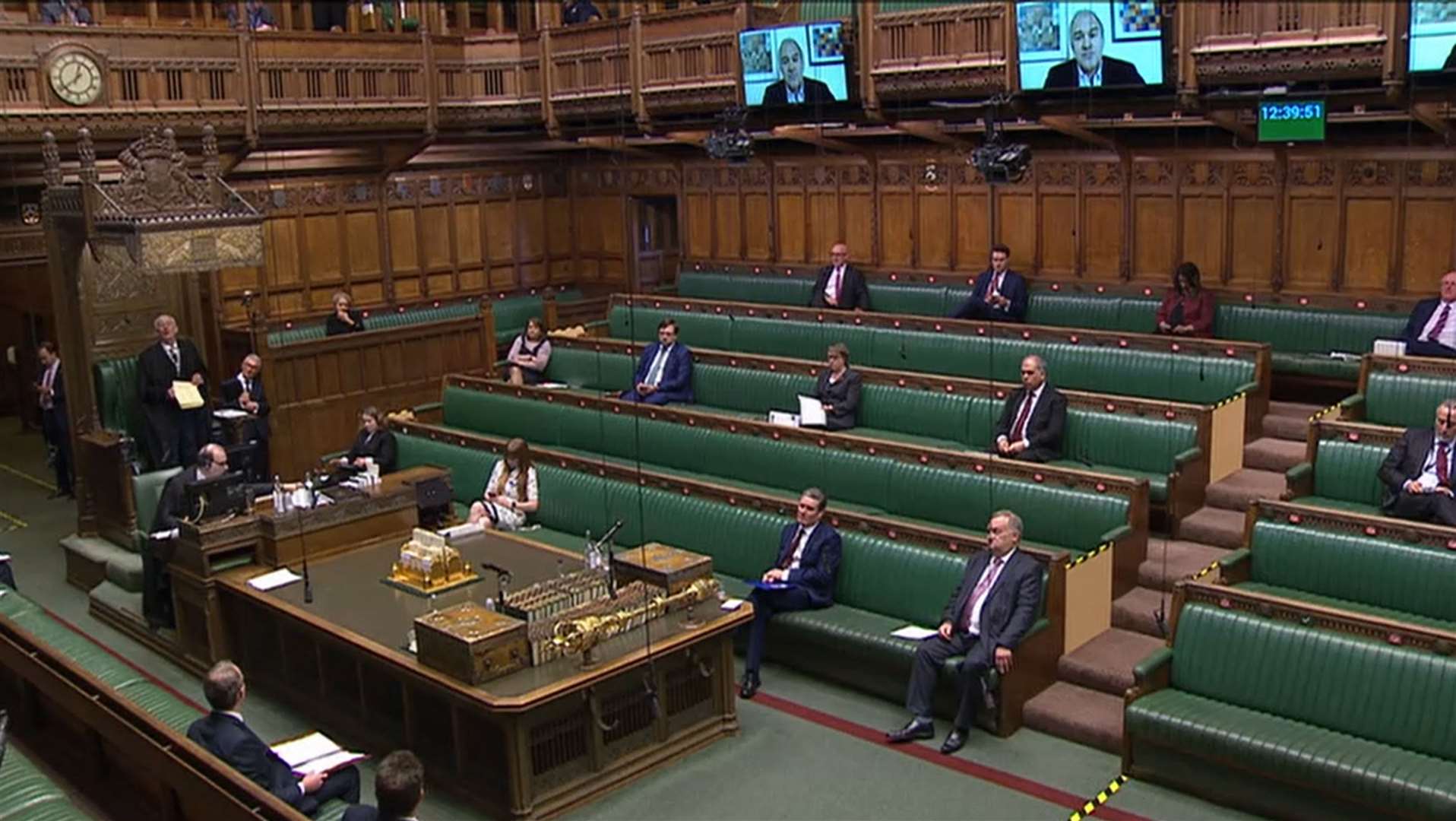 MPs can contribute remotely via screens around the chamber (House of Commons/PA)