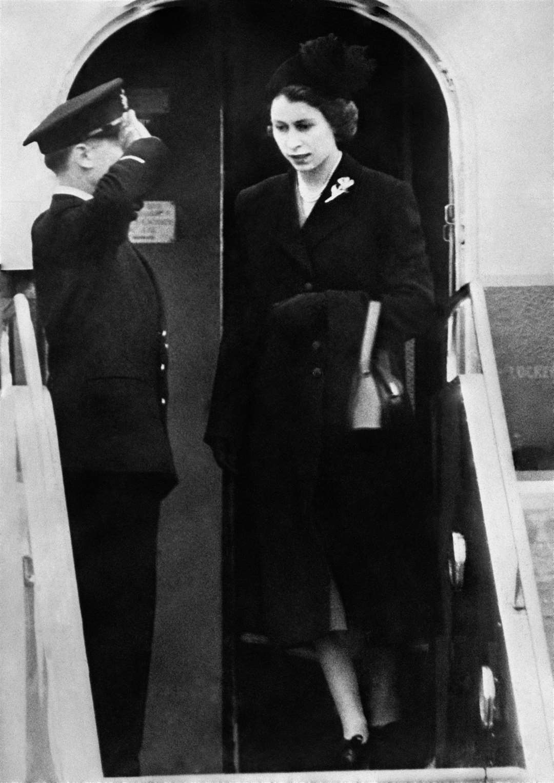 Queen Elizabeth II returns from Kenya where she was told of the death of her father King George VI (PA)