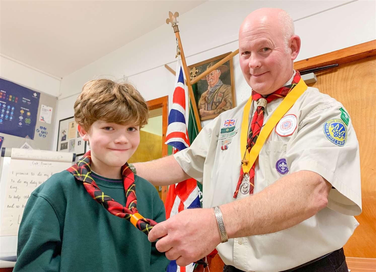 Group leader John Innes presents Rafi Whitney with his 1st Forres Cub necker.