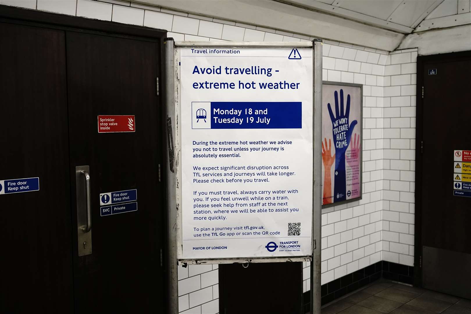 A sign warning passengers of traveling in the heat on the Bakerloo line of the London underground (Aaron Chown/PA)