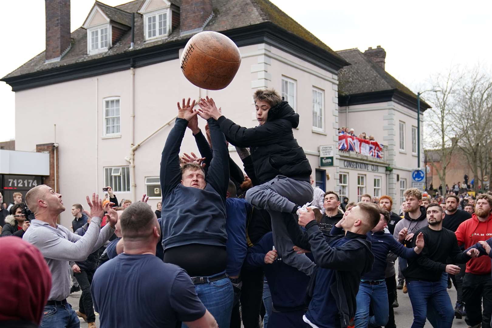 Players battle for possession during the Atherstone Ball Game in Warwickshire, which honours a match played between Leicestershire and Warwickshire in 1199, when teams used a bag of gold as a ball (Joe Giddens/PA)